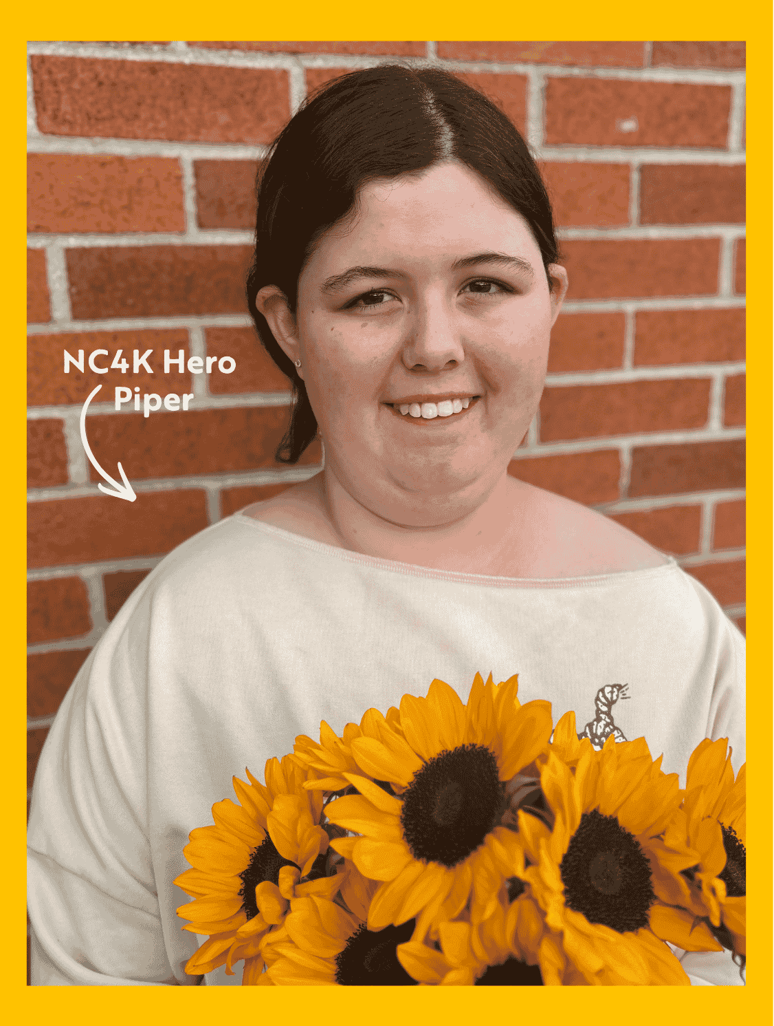One teenage girl smiling, holding sunflowers. One is NC4K Hero Laura and the other NC4K Sibling Katie. 